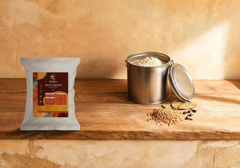 SatRas Sona Moti atta pouch beside an airtight steel canister of wheat flour, whole grains, bay leaves and cloves