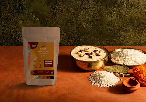SatRas Govind Bhog rice pouch beside a brass bowl of payesh, cooked short-grain rice and raw gobindobhog grains