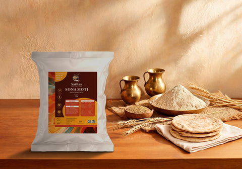 SatRas Sona Moti whole wheat atta pouch beside a brass thali of atta, wheat grains, wheat stalks and phulkas