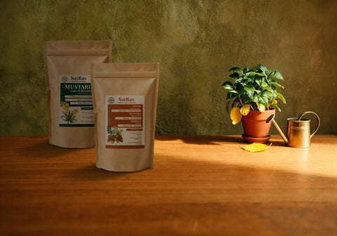 SatRas mustard cake fertiliser and plant growth promoter kraft pouches beside a potted plant with yellowing lower leaves and a brass watering can